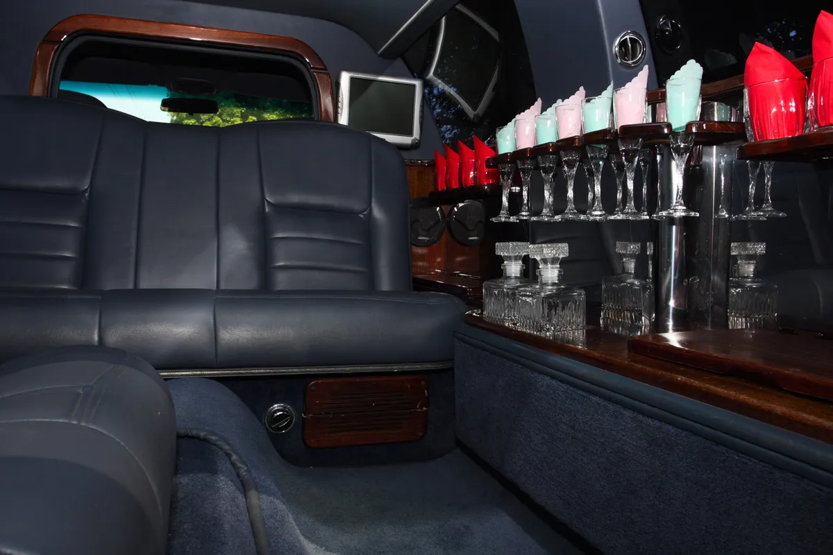 Luxurious limousine interior featuring plush seating and elegant decor, ideal for special events.