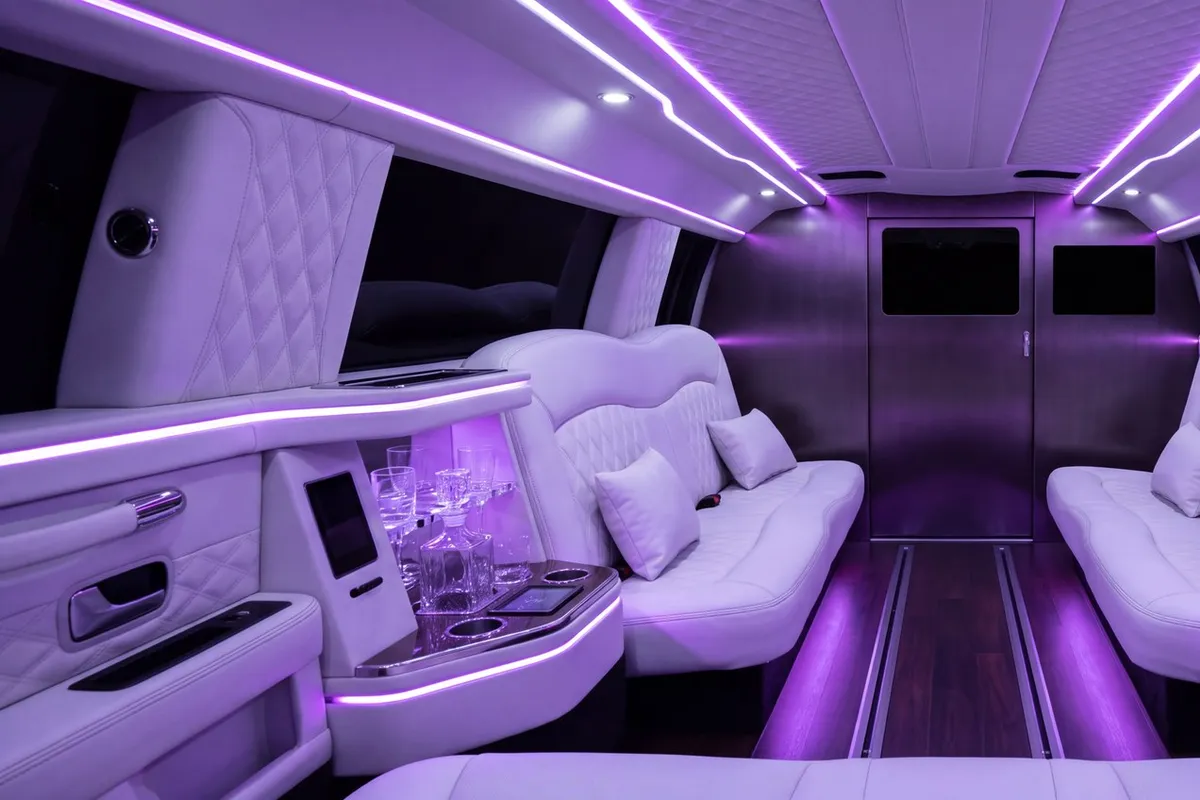 Luxurious limousine interior with white quilted leather seats and purple ambient lighting for VIP experiences.